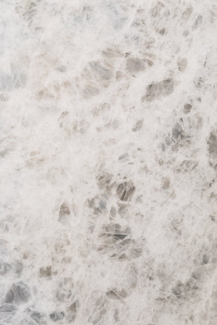 Close-up of white marble with intricate patterns and textures, perfect for elegant backgrounds.